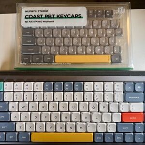 NuPhy Air75 V2 portable 75% mechanical keyboard and a package of NuPhy Studio Co